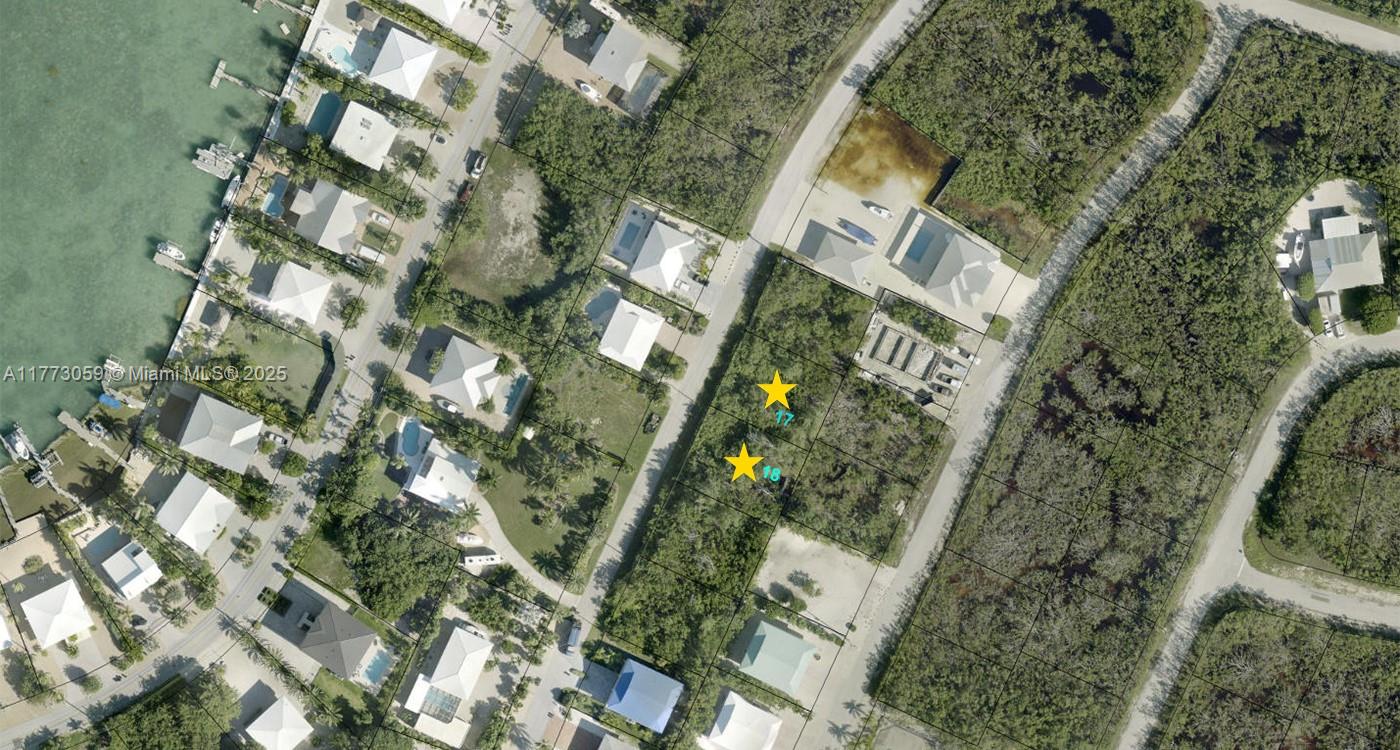 This aerial map shows two adjacent vacant lots marked with stars in a residential area — Lot 18 Jamaica St, Duck FL 33050, DUCK, FL