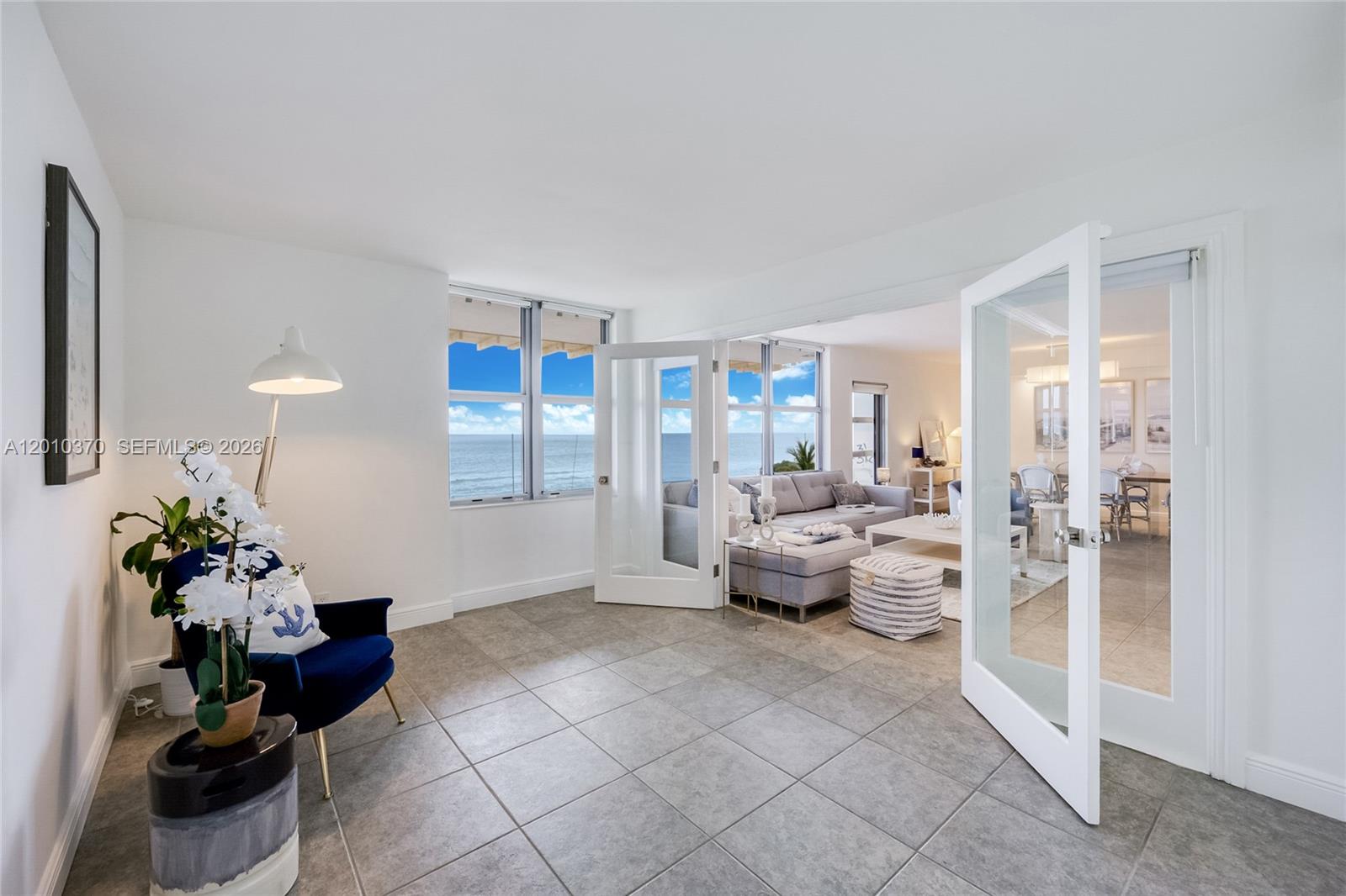 A bright room with tile floors and French doors leading to an oceanfront living area — 9225 Collins Ave # 501, Surfside FL 33154, SURFSIDE, FL