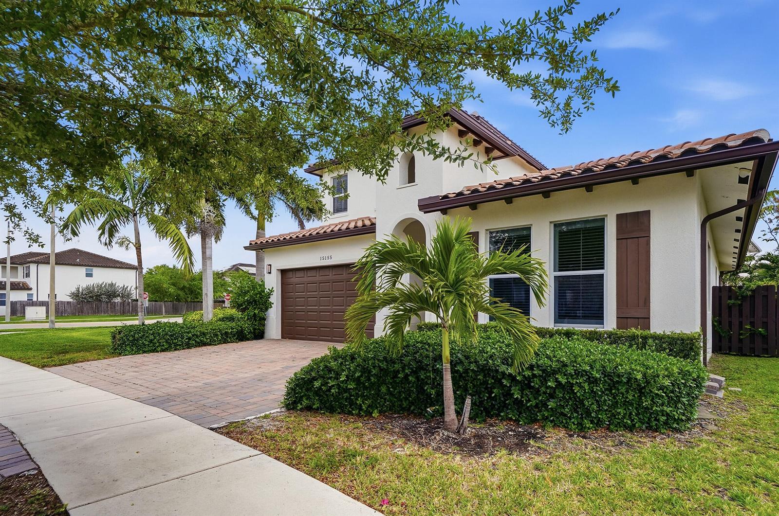 A two-story stucco house with a tile roof, brown garage door, and a palm tree — 15155 SW 176th Lane, Miami FL 33187, MIAMI, FL