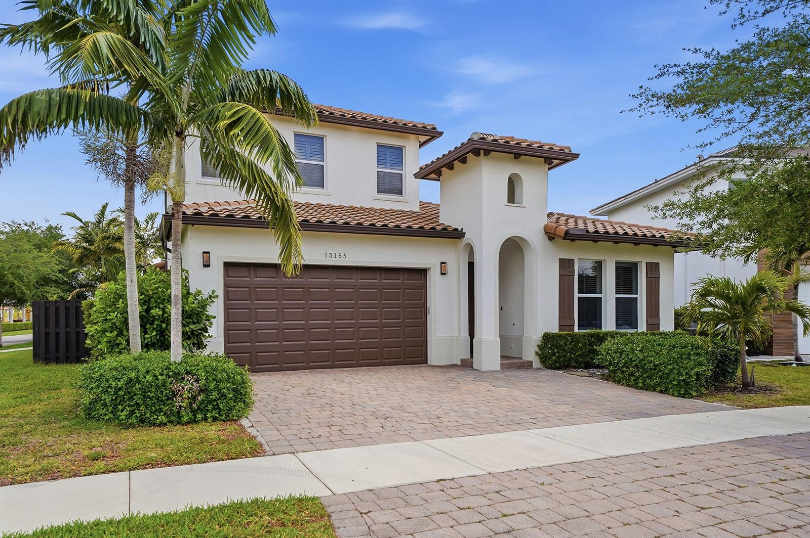 A two-story stucco house with a brown garage door and a tiled roof — 15155 SW 176th Lane, Miami FL 33187, MIAMI, FL