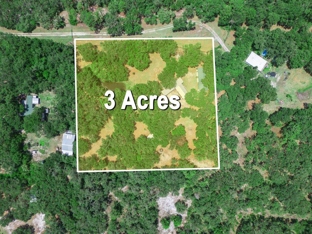 An aerial view shows a rectangular three-acre plot of land featuring trees and a house — 12627 BLACKBERRY LANE, LAKE WALES, FL