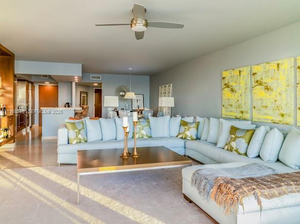 A living room features a large sectional sofa, a coffee table, and a ceiling fan — 450 Alton Rd # 1202, Miami Beach FL 33139, MIAMI BEACH, FL