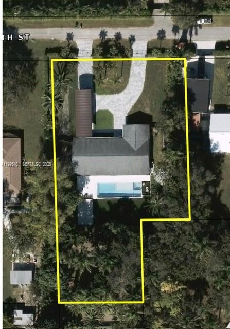 This aerial view shows a residential property with a house, pool, and large wooded backyard — 18840 SW 218th St, Miami FL 33170, MIAMI, FL