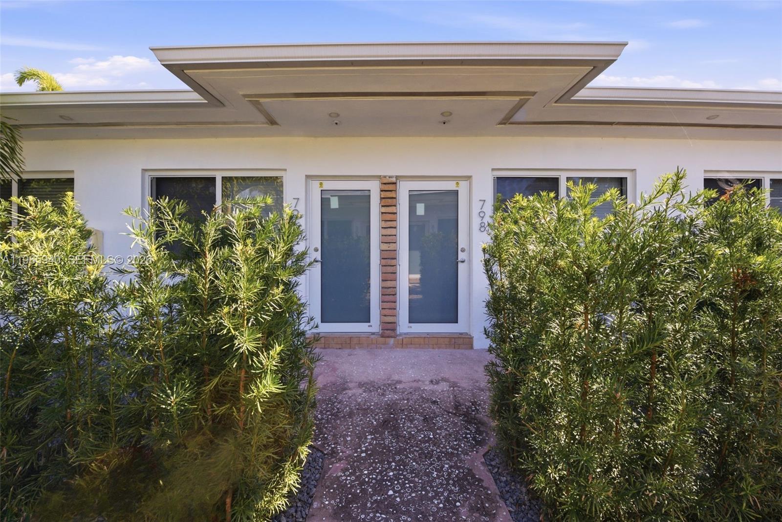 The exterior of a duplex building features two glass doors and a flat roof overhang — 800 85th St, Miami Beach FL 33141, MIAMI BEACH, FL