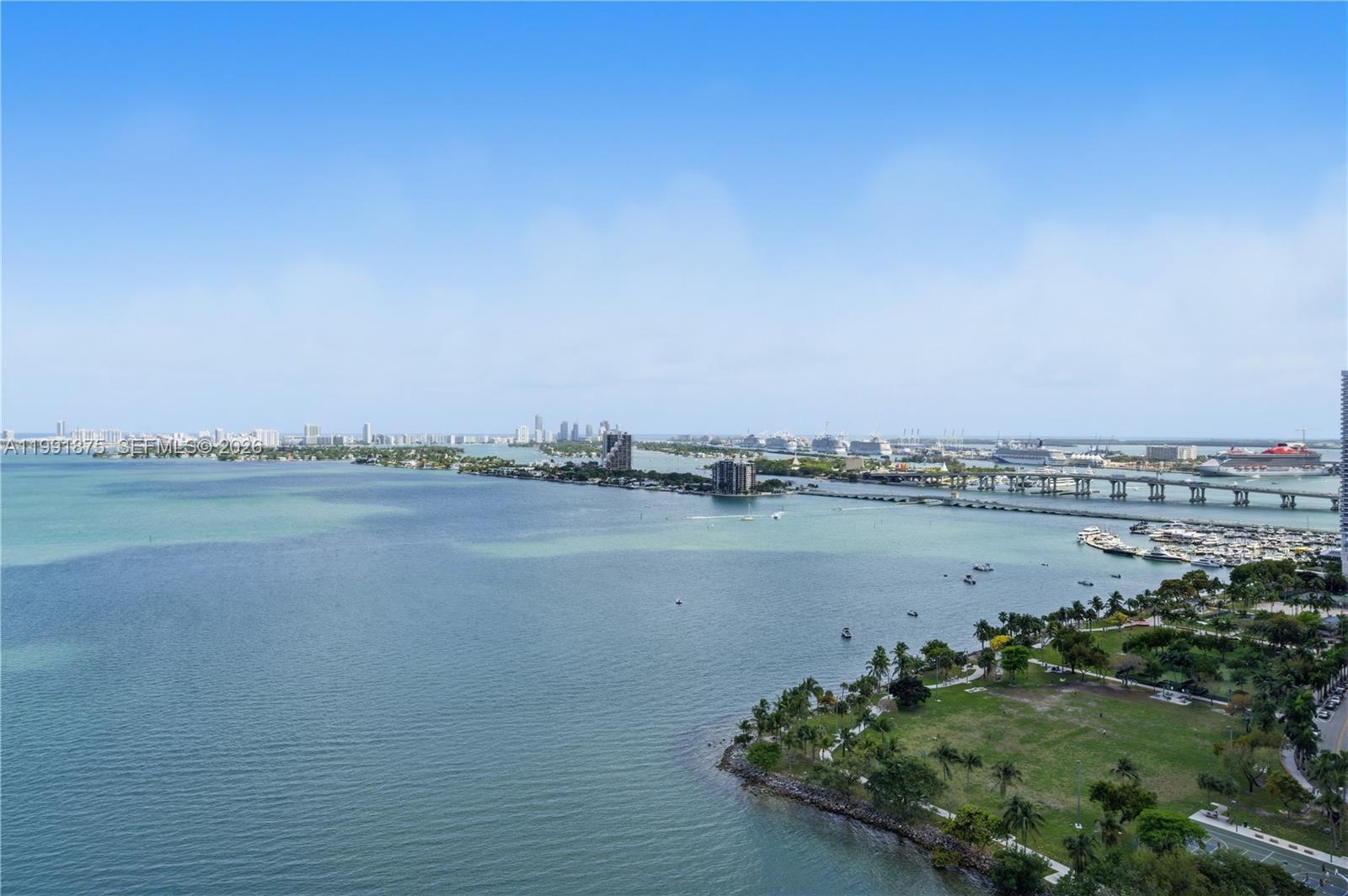 An elevated view shows a bay, a park, a bridge, and a distant city skyline — 2020 N Bayshore Dr # 2502, Miami FL 33137, MIAMI, FL
