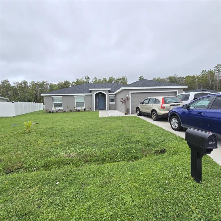 A single-story gray house with a two-car garage and a front lawn — 540 BRISTOL CIRCLE, KISSIMMEE, FL