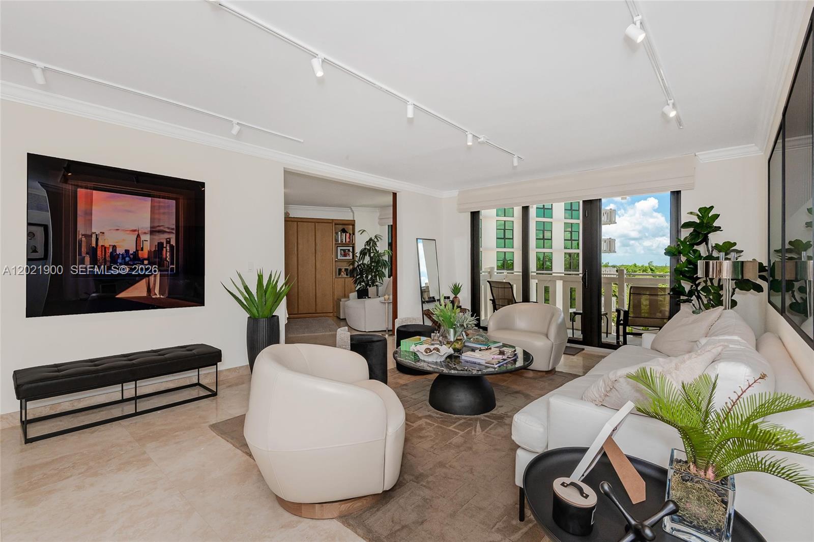 A modern living room features a white sofa, cream armchairs, a marble coffee table, and balcony — 1121 Crandon Blvd # E405, Key Biscayne FL 33149, KEY BISCAYNE, FL