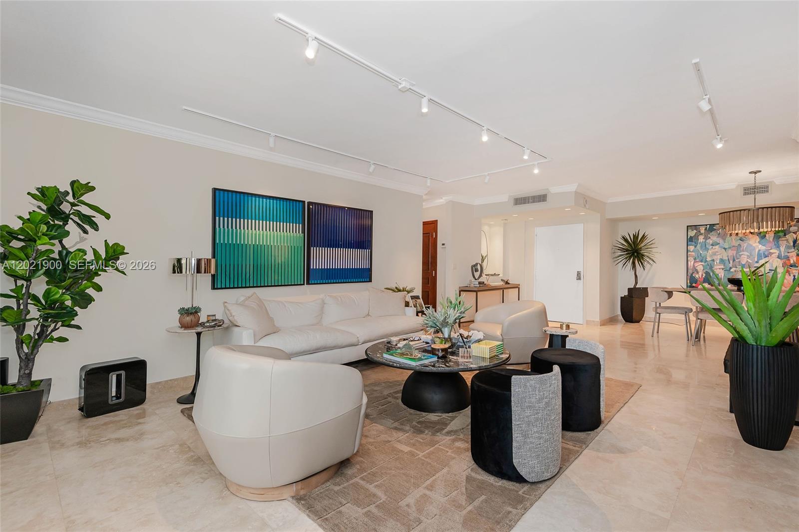 A living room features a white sofa, two armchairs, a round coffee table, and artwork — 1121 Crandon Blvd # E405, Key Biscayne FL 33149, KEY BISCAYNE, FL