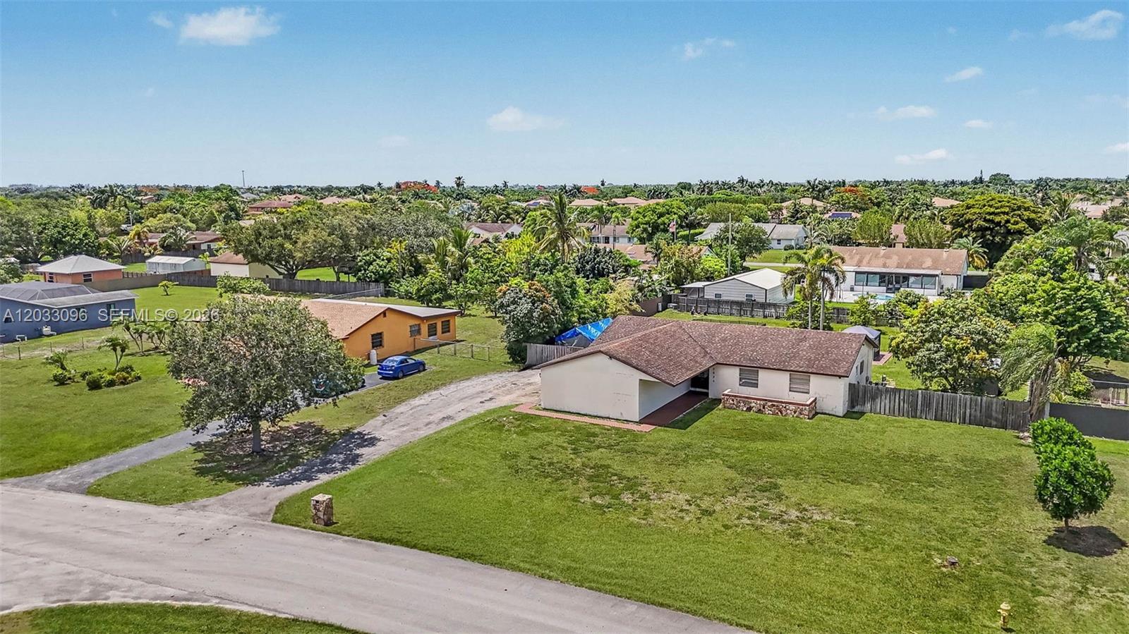 An aerial view shows two single-story houses with large lawns and driveways in a neighborhood — 1475 NW 19 ST, Homestead FL 33030, HOMESTEAD, FL