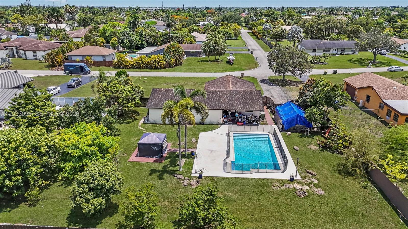 An aerial view shows a house with a backyard pool, patio, and surrounding lawn — 1475 NW 19 ST, Homestead FL 33030, HOMESTEAD, FL