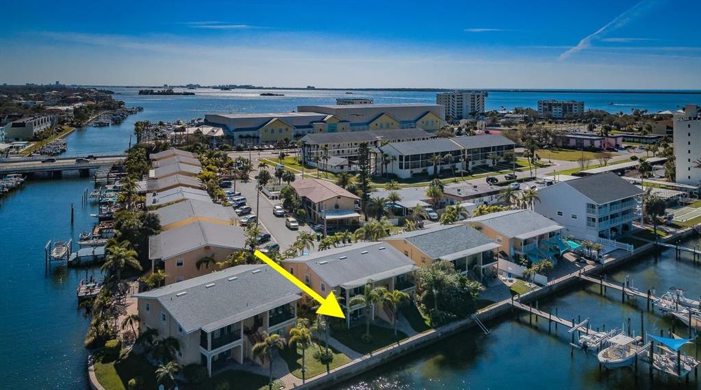 An aerial view of waterfront townhomes with private boat docks and palm trees — 2675 ST JOSEPHS DRIVE E UNIT B, DUNEDIN, FL