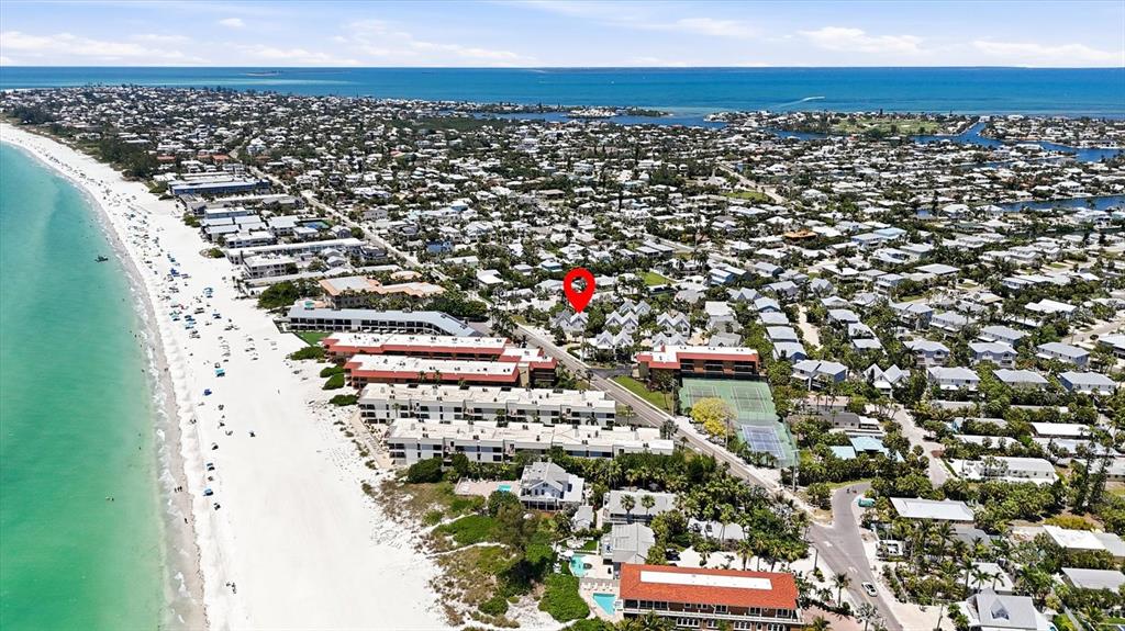 This aerial view shows a beachside resort community with a red location pin — 6325 GULF DRIVE, HOLMES BEACH, FL