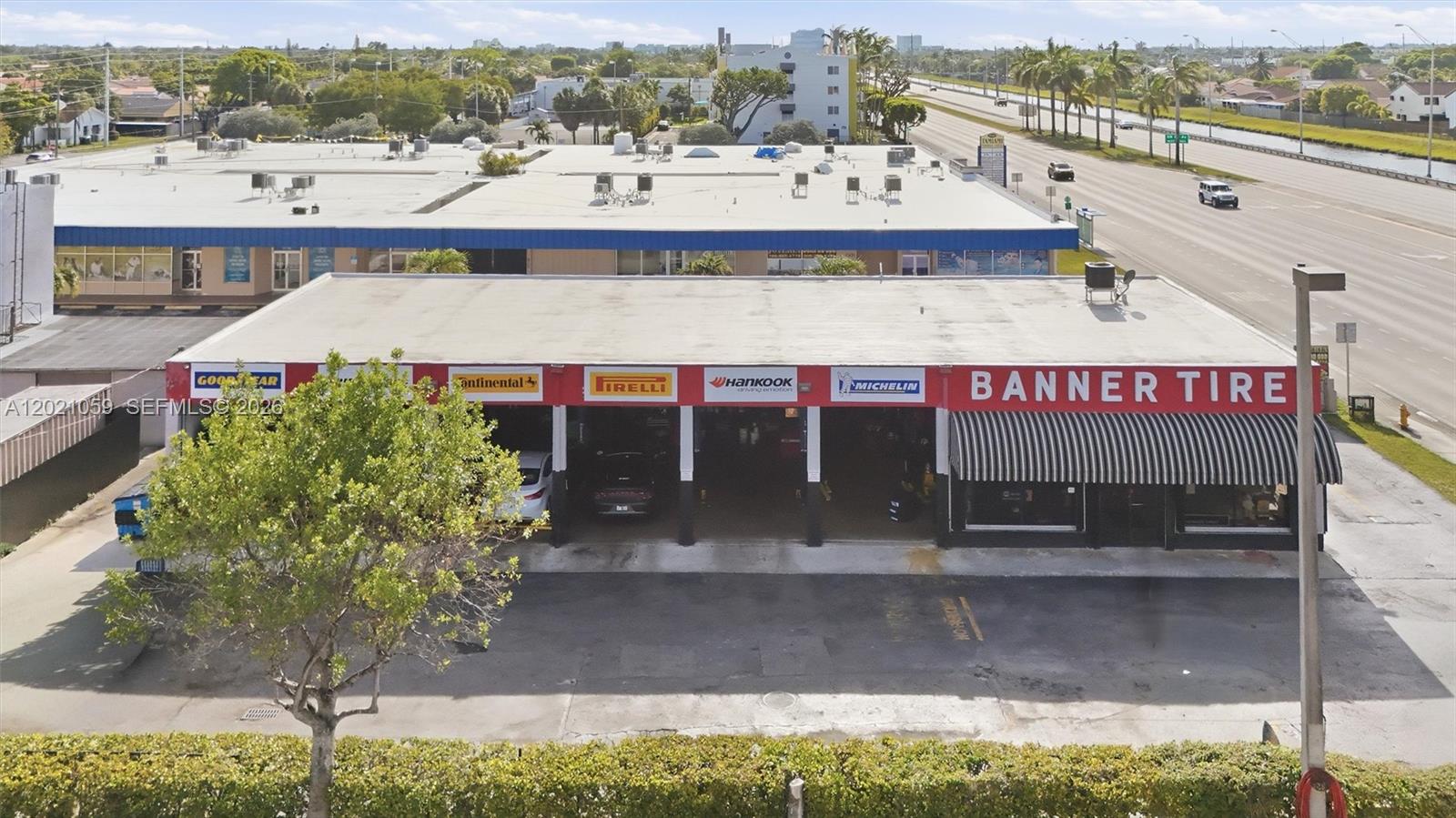 An aerial view shows a commercial tire shop building with multiple service bays and signage — 8730 SW 8th St, Miami FL 33174, MIAMI, FL