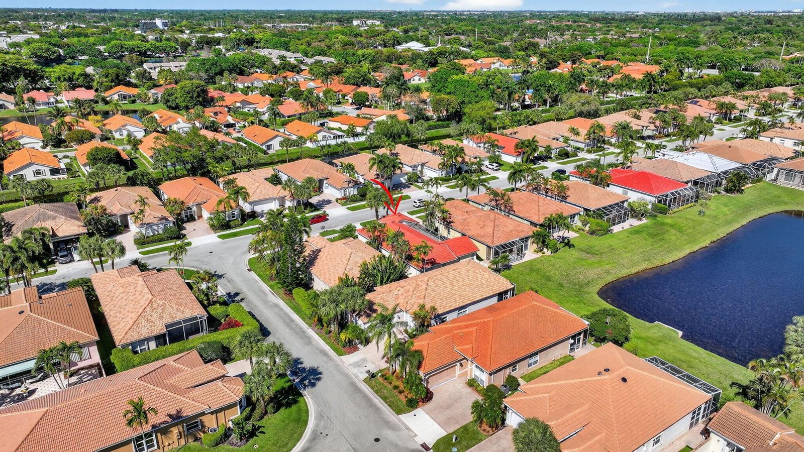 An aerial view shows a suburban neighborhood with houses featuring orange tile roofs and pools — 5176 Ventura Drive # 5176, Delray Beach FL 33484, DELRAY BEACH, FL