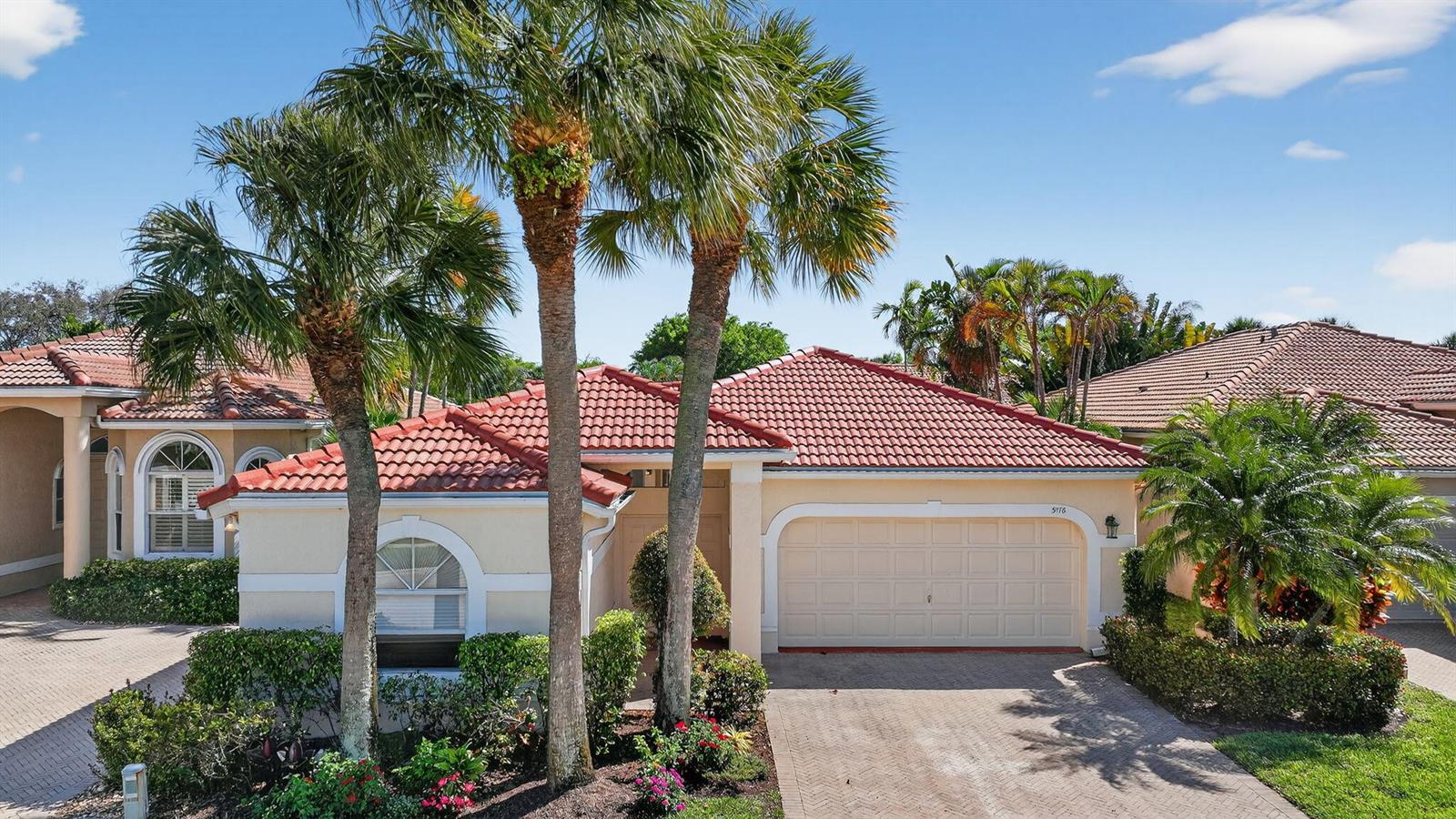 A single-story house with a red tile roof, beige stucco walls, and palm trees — 5176 Ventura Drive # 5176, Delray Beach FL 33484, DELRAY BEACH, FL