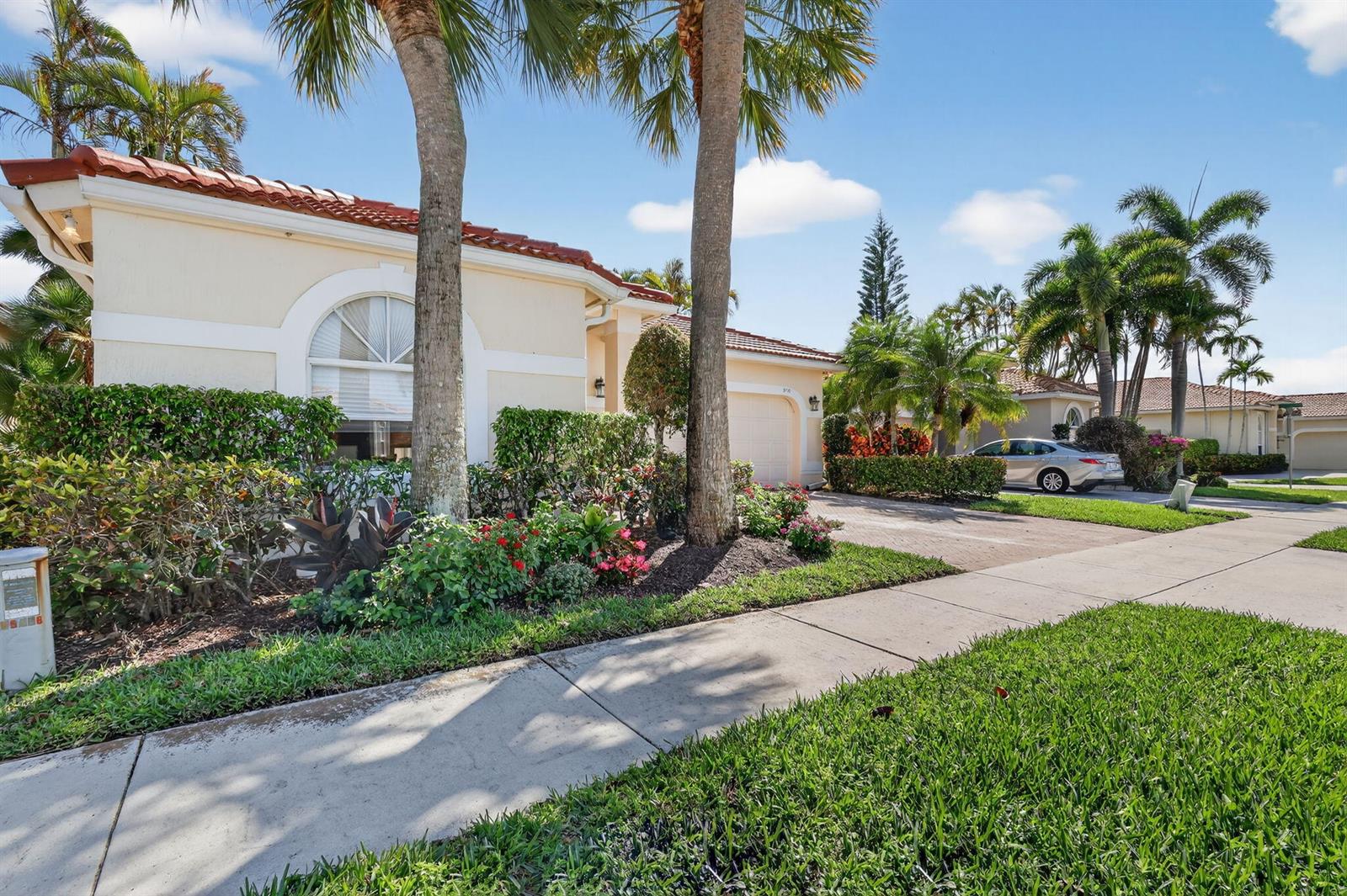 A single-story house with a tile roof, palm trees, and a driveway in a neighborhood — 5176 Ventura Drive # 5176, Delray Beach FL 33484, DELRAY BEACH, FL