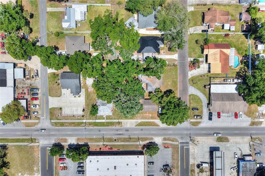 This aerial view shows a residential neighborhood with houses, trees, and paved streets — 503 MERRIN STREET, PLANT CITY, FL