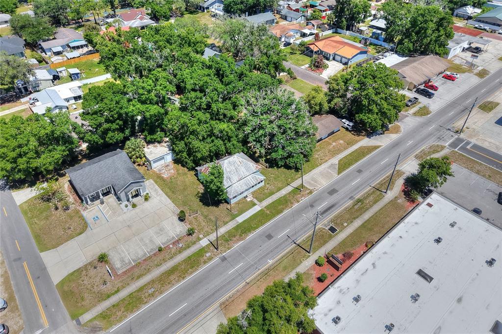 An aerial view shows two houses situated along a road near a commercial building — 503 MERRIN STREET, PLANT CITY, FL