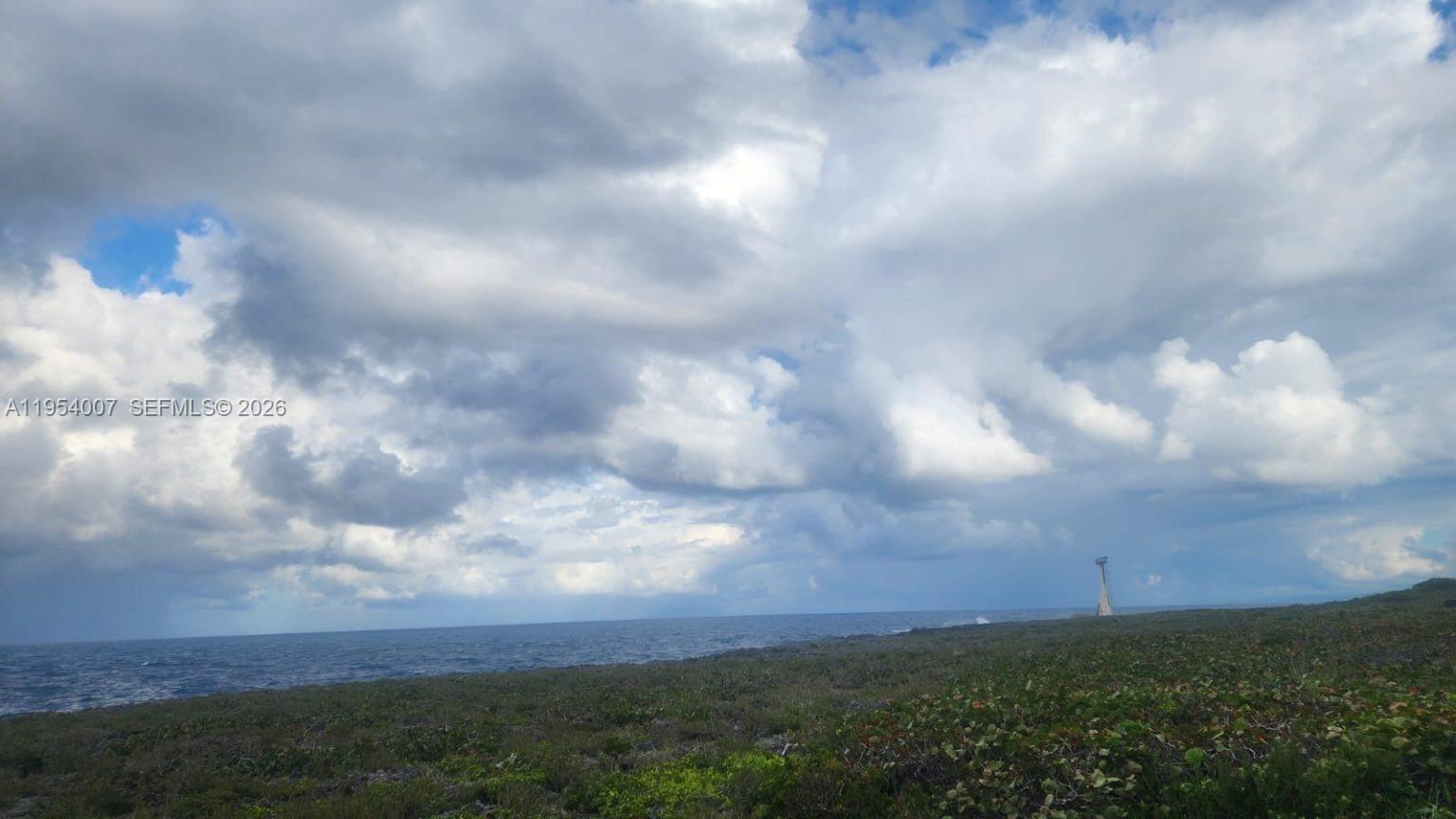 A view of a rocky coastline meeting the ocean under a cloudy sky — 00 Galina, St. Mary, Jamaica, FL, FL
