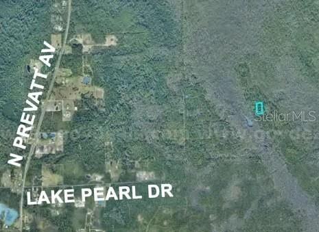 This is an aerial map showing a vacant lot outlined in blue near a road intersection — 7128-02-02-0160, LAKE HELEN, FL