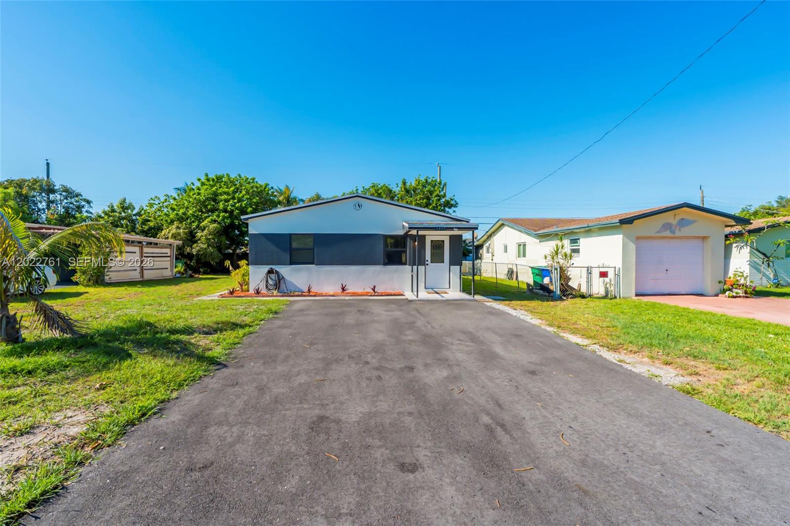 A single-story house with a dark gray and white exterior features a paved driveway — 6312 SW 19th St # 1, Miramar FL 33023, MIRAMAR, FL