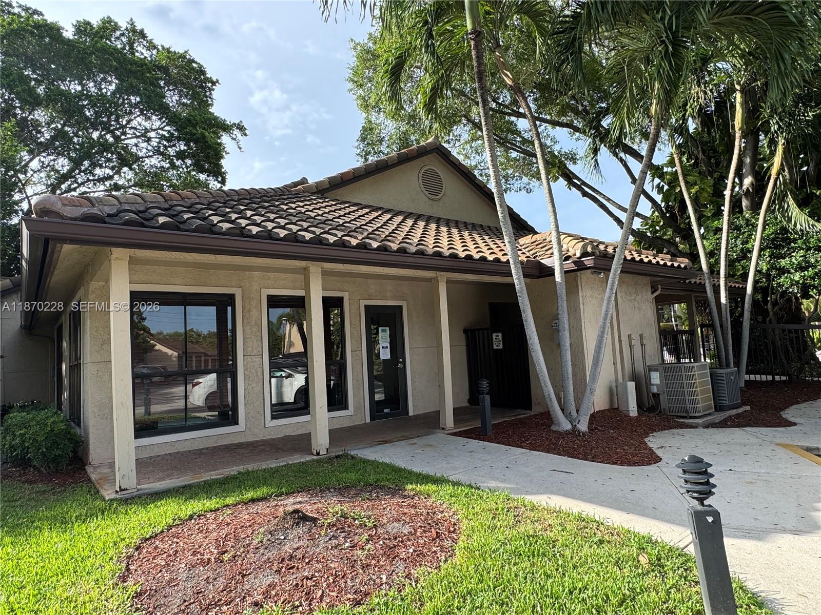 A single-story building with a tiled roof, stucco exterior, and a covered front walkway — 4341 W McNab Rd # 27, Pompano Beach FL 33069, POMPANO BEACH, FL