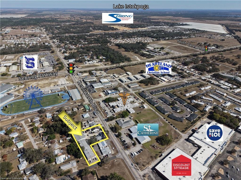 An aerial view of a commercial property outlined in yellow near a busy intersection — 2914 KENILWORTH BOULEVARD, SEBRING, FL