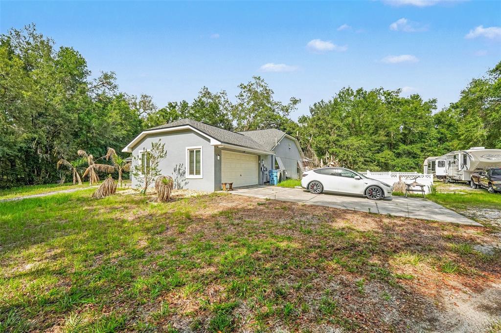 A single-story house with a garage and a white car parked in the driveway — 6350 BILTMORE AVENUE, WEBSTER, FL