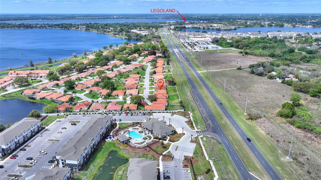 Aerial view of a residential neighborhood, a large apartment complex, and a nearby highway — 144 MORNING GLORY CIRCLE, WINTER HAVEN, FL