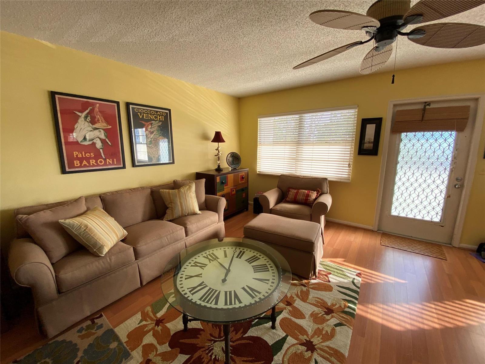 A living room features a tan sofa, matching armchair, ottoman, and a glass-topped clock coffee table — 19 Ashby A # 19, Deerfield Beach FL 33442, DEERFIELD BEACH, FL