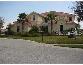 A two-story stucco house with a tile roof and palm trees in the front yard — 9712 SEA TURTLE TERRACE UNIT 102, BRADENTON, FL
