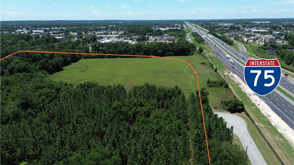 An aerial view shows a large, undeveloped grassy lot adjacent to Interstate 75 — NW 37TH STREET, OCALA, FL
