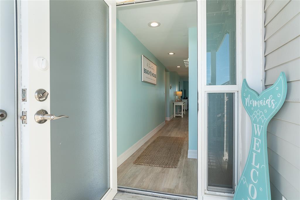A view through an open front door into a hallway with light blue walls — 7466 PALM ISLAND DRIVE UNIT 2911, PLACIDA, FL