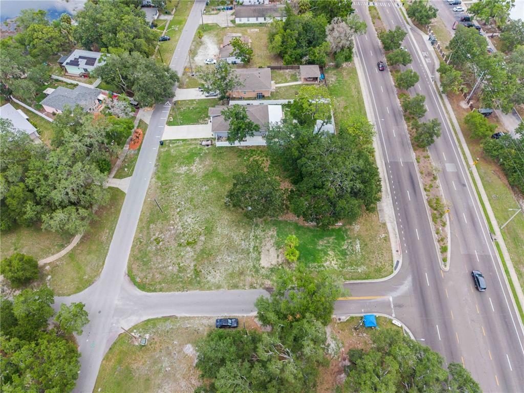 An aerial view shows a vacant lot situated between a residential street and a highway — 7514 N 40TH STREET, TAMPA, FL