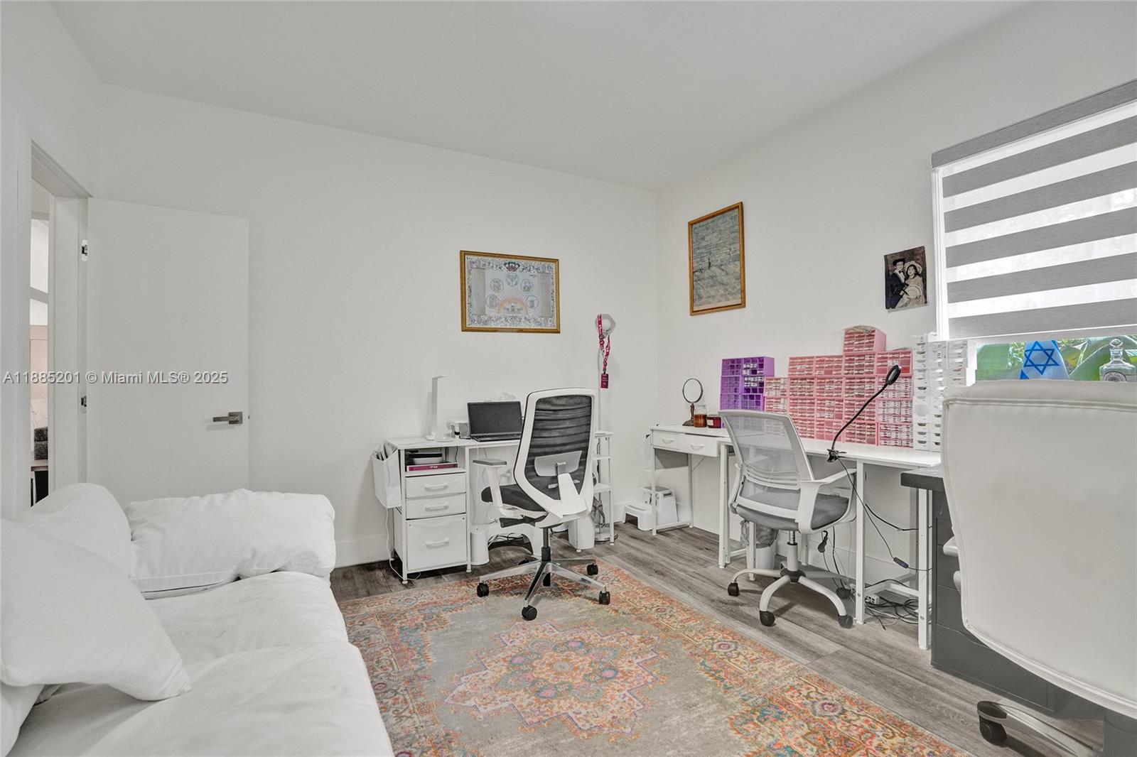 A home office features two desks, ergonomic chairs, a white sofa, and a patterned rug — 3784 Sheridan Ave, Miami Beach FL 33140, MIAMI BEACH, FL