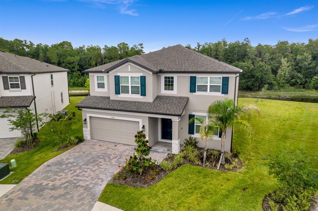 An aerial view of a two-story suburban house with a paved driveway and green lawn — 10742 NEW MORNING DRIVE, TAMPA, FL