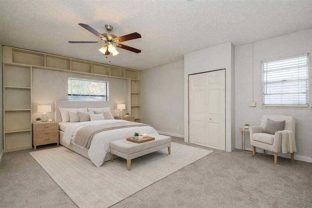 A bedroom features a bed with built-in shelving, a ceiling fan, and a corner armchair — 505 E MORGAN STREET, TARPON SPRINGS, FL