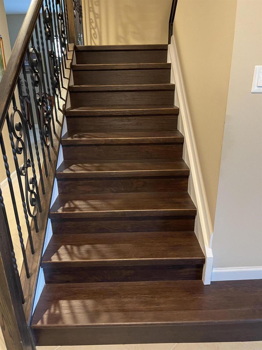 A staircase with dark wood treads and a black wrought iron railing — 2916 Payson Way, Wellington FL 33414, WELLINGTON, FL