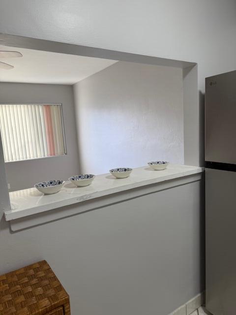 A kitchen features white cabinets, stainless steel appliances, a double sink, and tiled flooring — 3320 Lake Osborne Drive # 107, FL 33461, FL