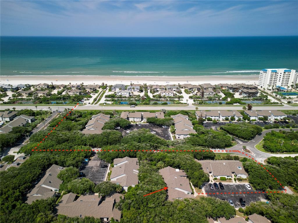 An aerial view shows a residential complex with red dashed lines outlining a property boundary — 4438 SEA MIST DRIVE UNIT 4438, NEW SMYRNA BEACH, FL