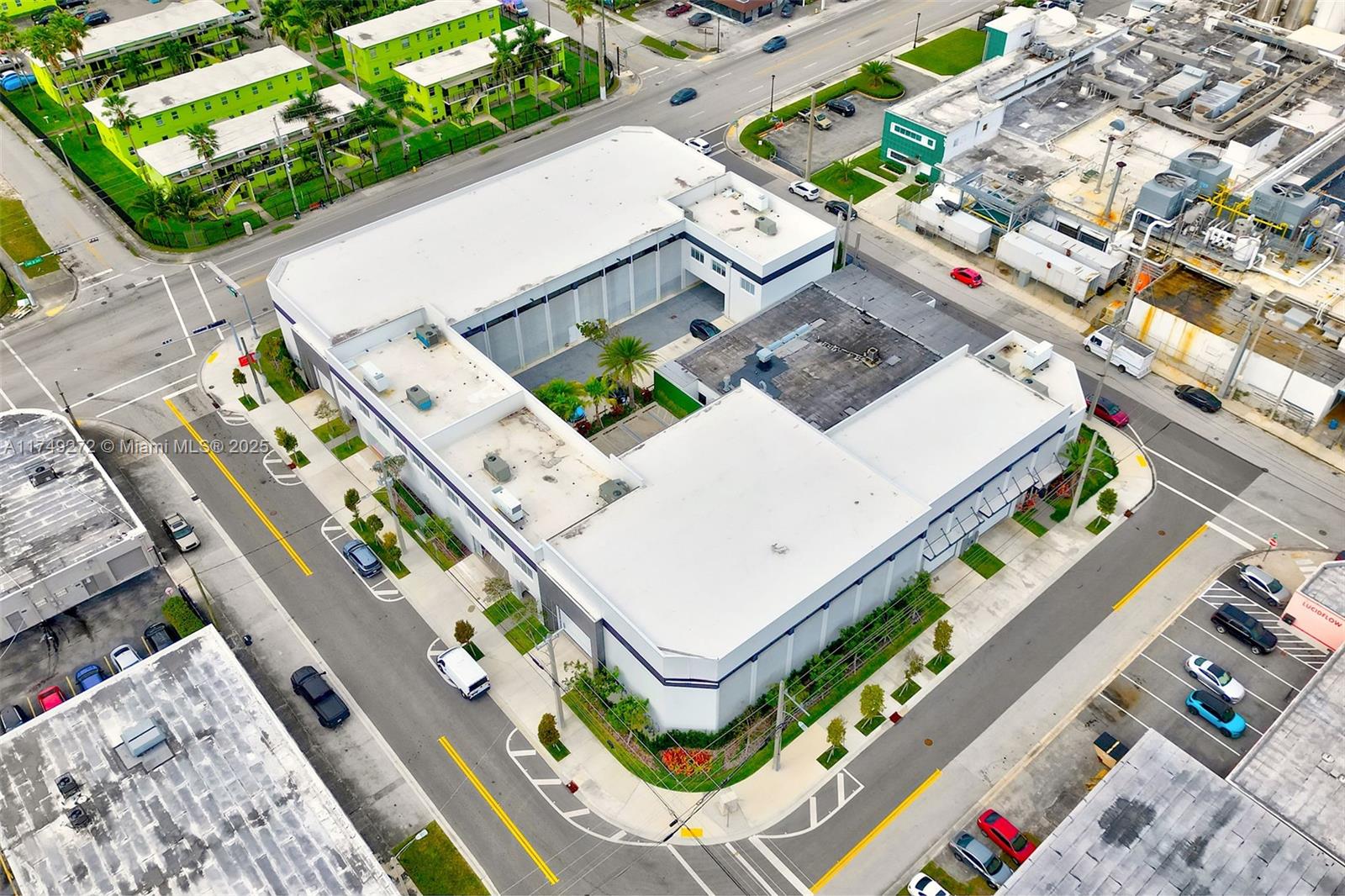 An aerial view shows a white commercial building with a central courtyard and surrounding streets — 235 NE 67th St # 3, Miami FL 33138, MIAMI, FL