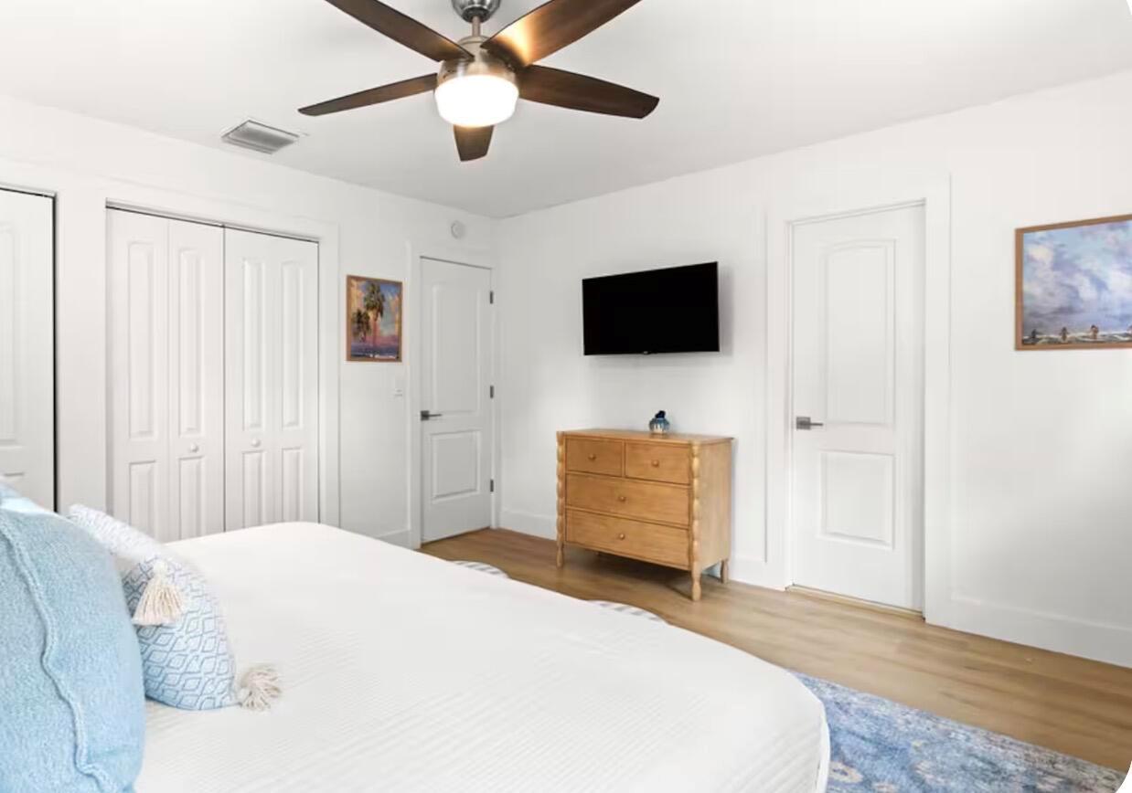 A kitchen with white cabinets, stainless steel appliances, gray subway tile backsplash, and light wood flooring — 1216 Surf Road, Singer Island FL 33404, SINGER ISLAND, FL