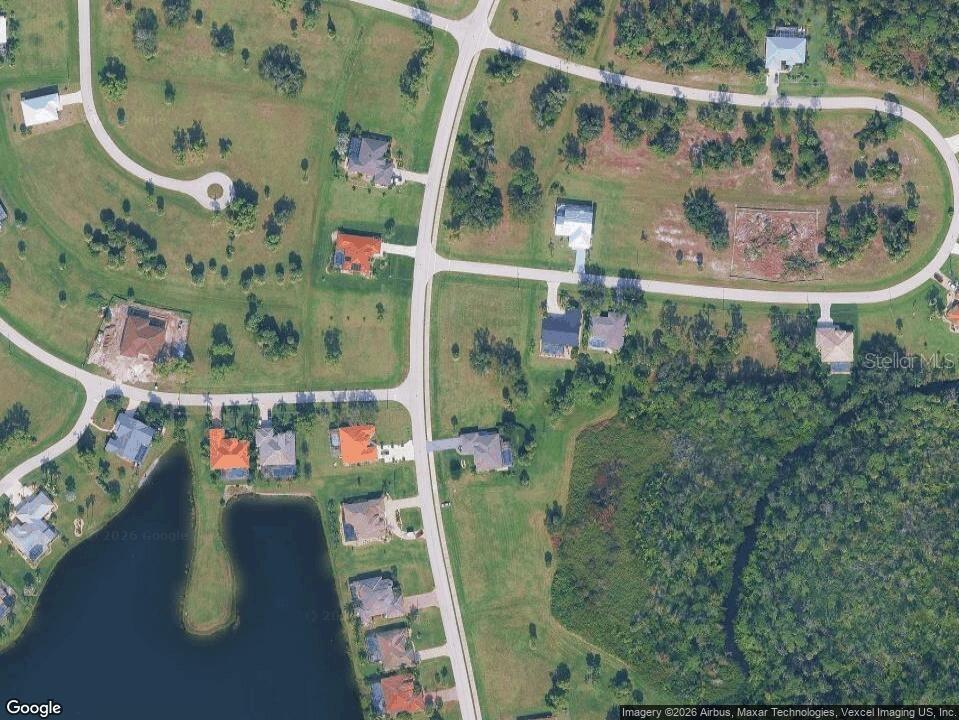 This aerial map shows a residential neighborhood with houses, roads, and a lake — 17052 CAPE HORN BOULEVARD, PUNTA GORDA, FL