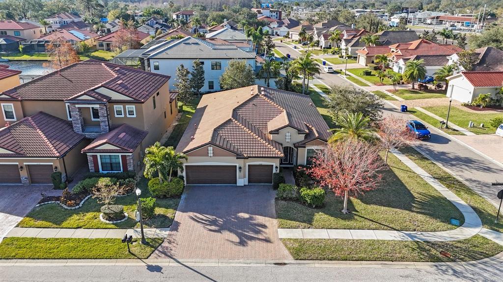 An aerial view of a suburban house with a tiled roof and a paved driveway — 2564 GRAND CYPRESS BOULEVARD, PALM HARBOR, FL