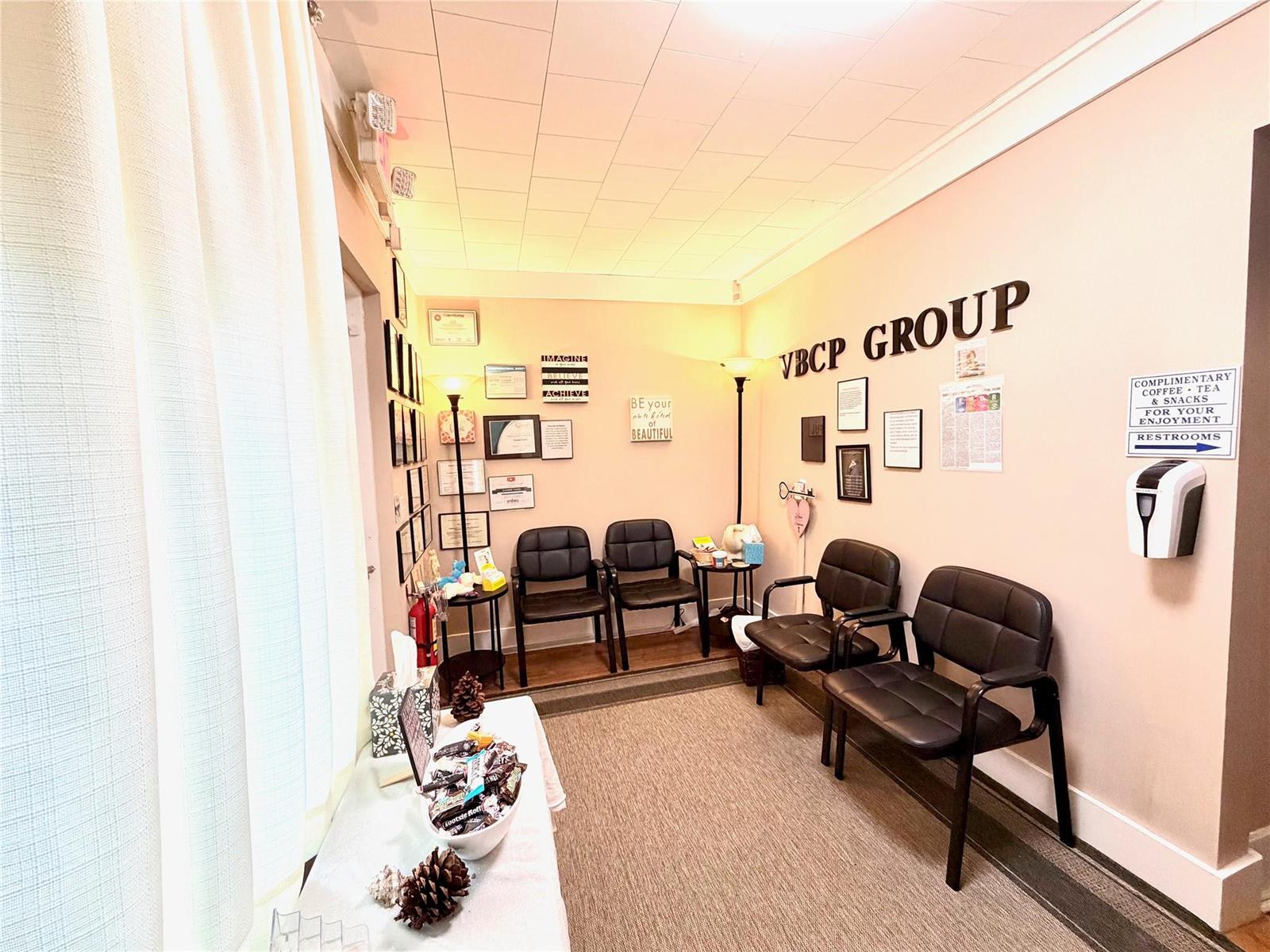 A waiting room features black chairs, framed wall art, and a snack station — 1925 20th Street, Vero Beach FL 32960, VERO BEACH, FL