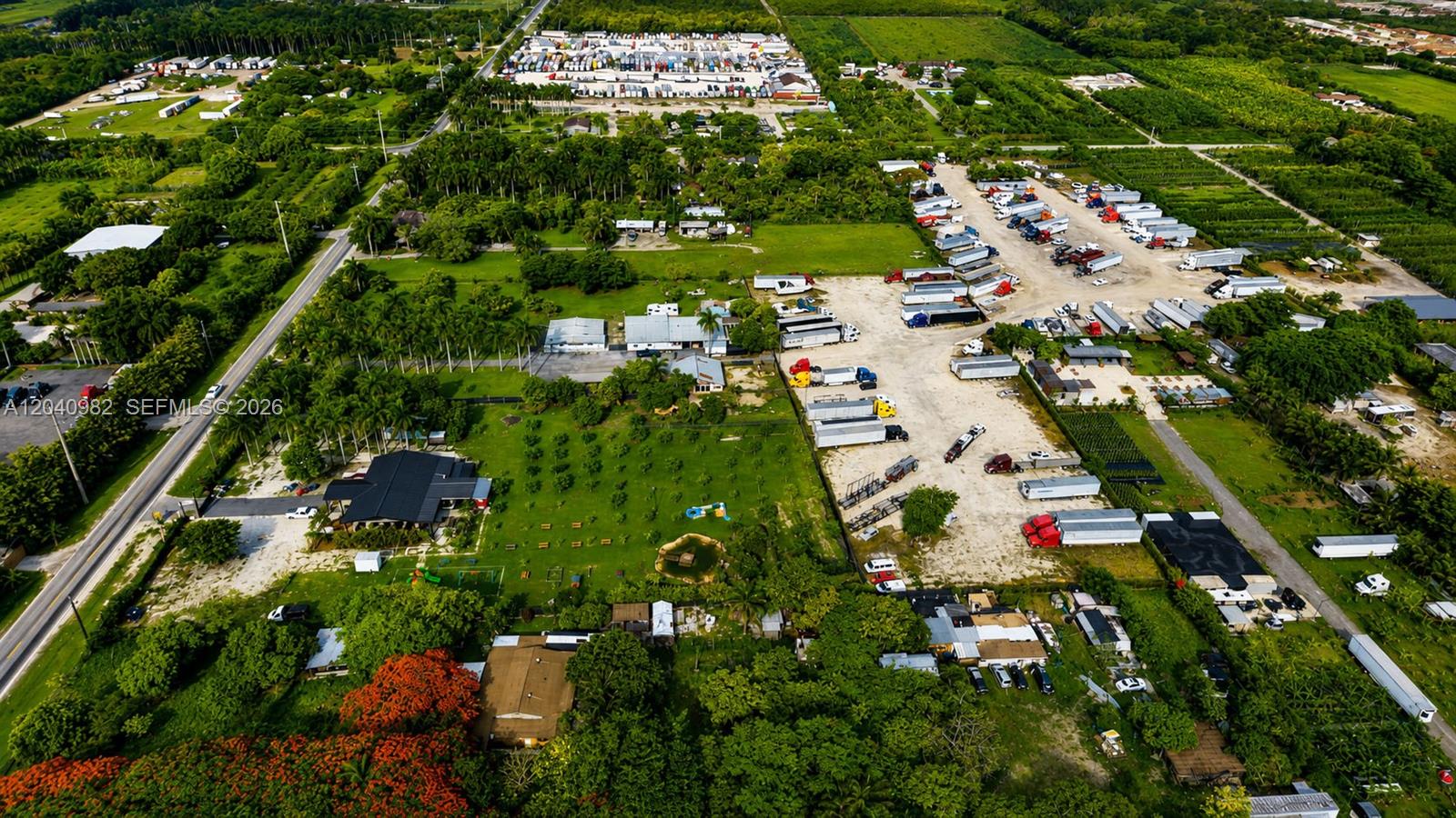 An aerial view shows a rural property with a house, orchard, and truck parking lot — 19790 SW 136th St, Miami FL 33196, MIAMI, FL