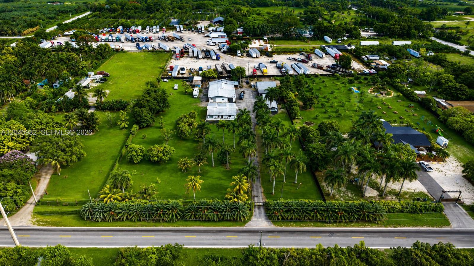 An aerial view shows a commercial trucking lot with parked trailers and a residential property — 19790 SW 136th St, Miami FL 33196, MIAMI, FL