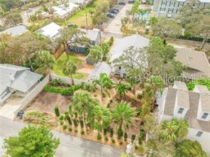 An aerial view shows a residential lot with landscaping, palm trees, and surrounding houses — 217 ESTHER STREET, NEW SMYRNA BEACH, FL