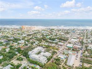An aerial view of a coastal town featuring houses, streets, and a beach with ocean — 217 ESTHER STREET, NEW SMYRNA BEACH, FL