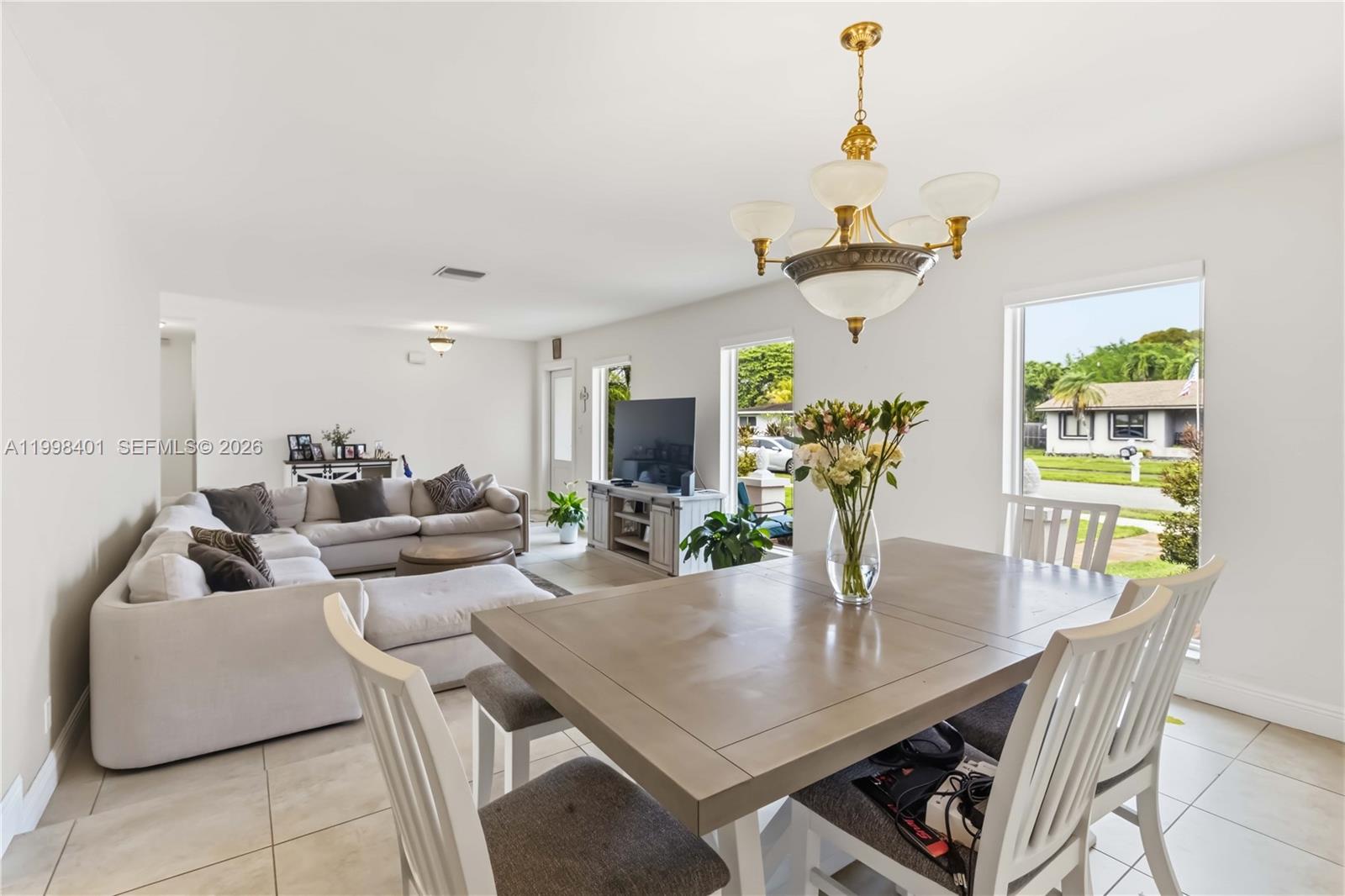 The exterior of a house features a white door, a large window, and tiled flooring — 19911 SW 84th Ave, Cutler Bay FL 33189, CUTLER BAY, FL